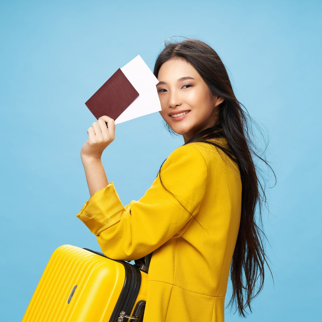 Happy Female Traveler Holding Passport and Suitcase-widen Happy Female Traveler Holding Passport and Suitcase-widen